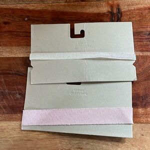 2 Urban Outfitters ribbon chokers. 1 pink, 1 white/pearl/shiny. NWT. Never worn
